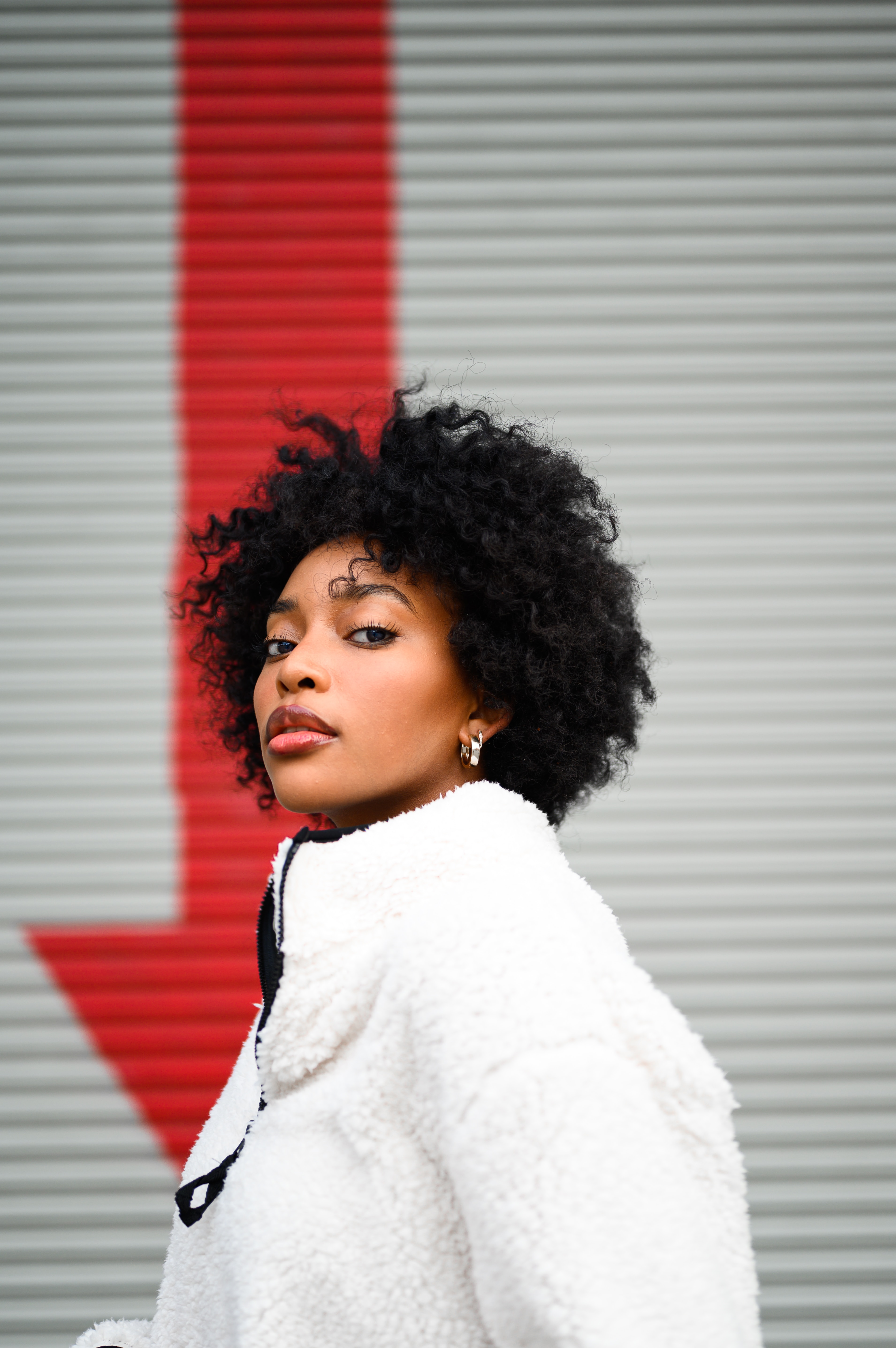 Black girl wearing a white jacket